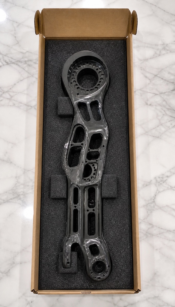 Long-slot foam packaging for a black anodized humanoid robot shank bracket