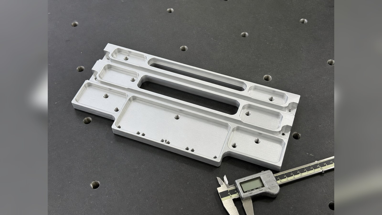 Trial Machining of an Aluminum Slide Structure for Communication Power Modules: Hole-Slot Relationships and Burr Control