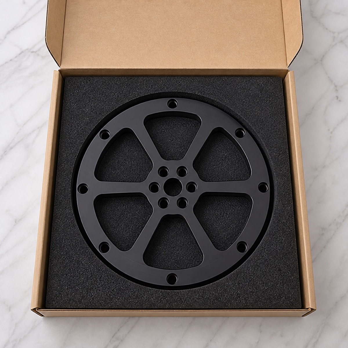 Protected foam packaging for a black anodized robot second-axis swing arm flange